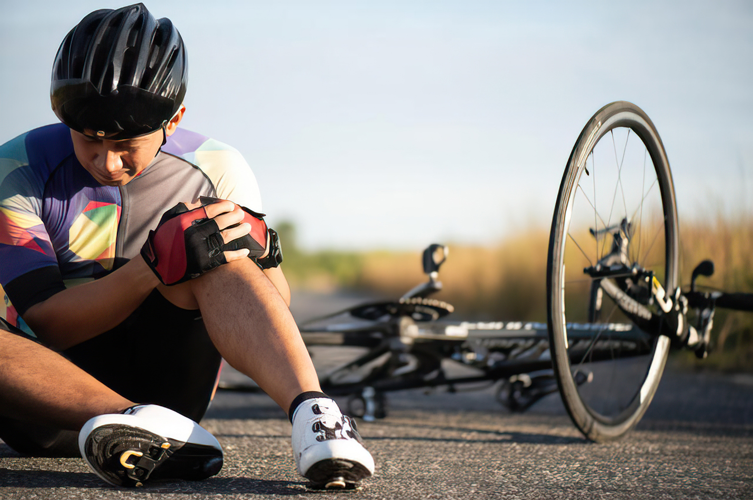 w9ndpt-gigapixel-low_res-scale-4_00x Cyclist with a knee injury sitting beside a bicycle